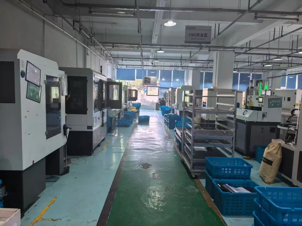 Machining equipment and material-handling trays in the CNC work area.
