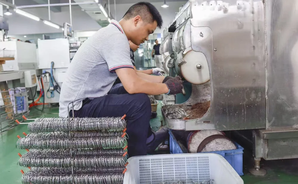Manual polishing of metal frame components.